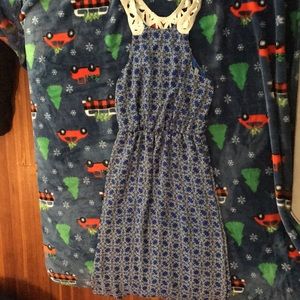 A blue dress with white lace detailed straps